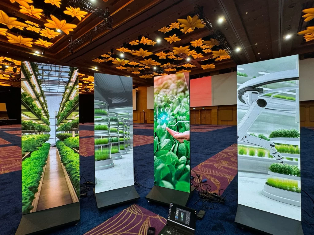 Four LED posters, displayed in a row, each showcasing different content.